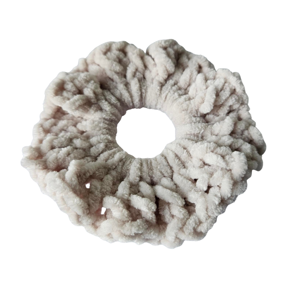 Fluffy beige scrunchie on a white background