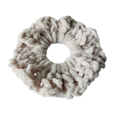 Fluffy beige scrunchie on a white background