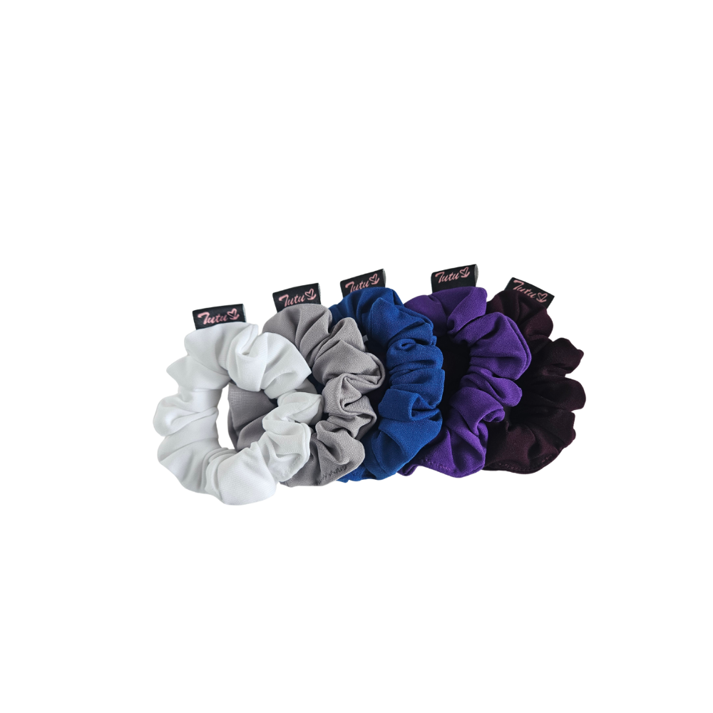 Five fabric hair scrunchies in white, gray, blue, purple, and black, arranged in a row on a plain white background.